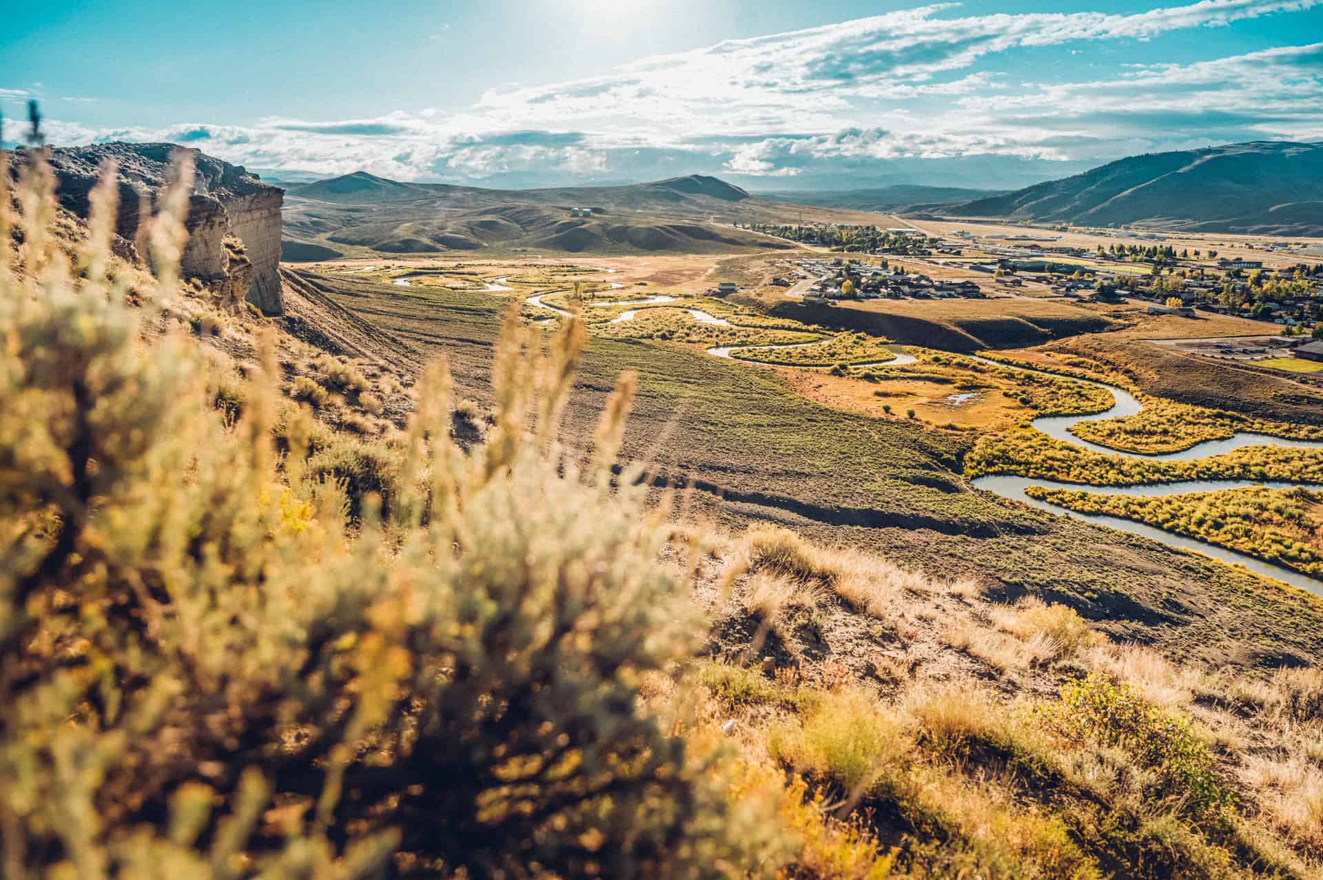 A landscape with a river and mountains.