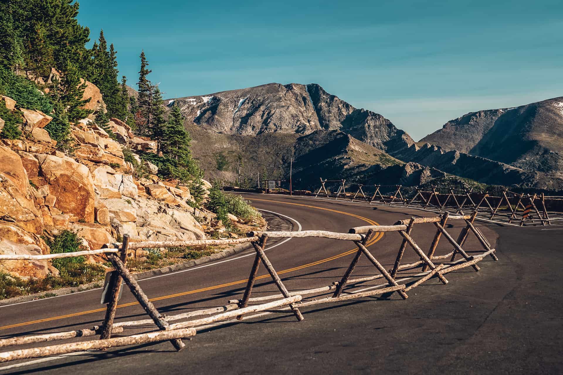 A wooden fence on a mountain road.