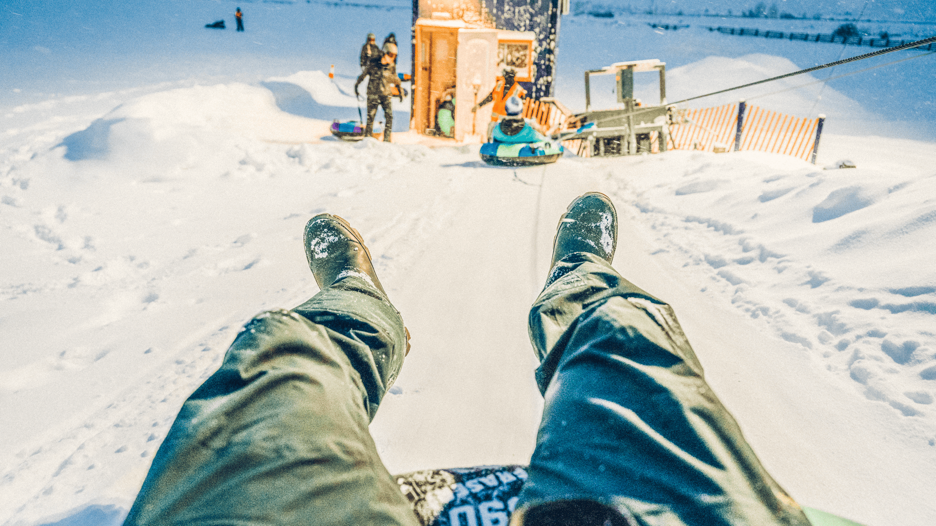 A person riding a sled in the snow.