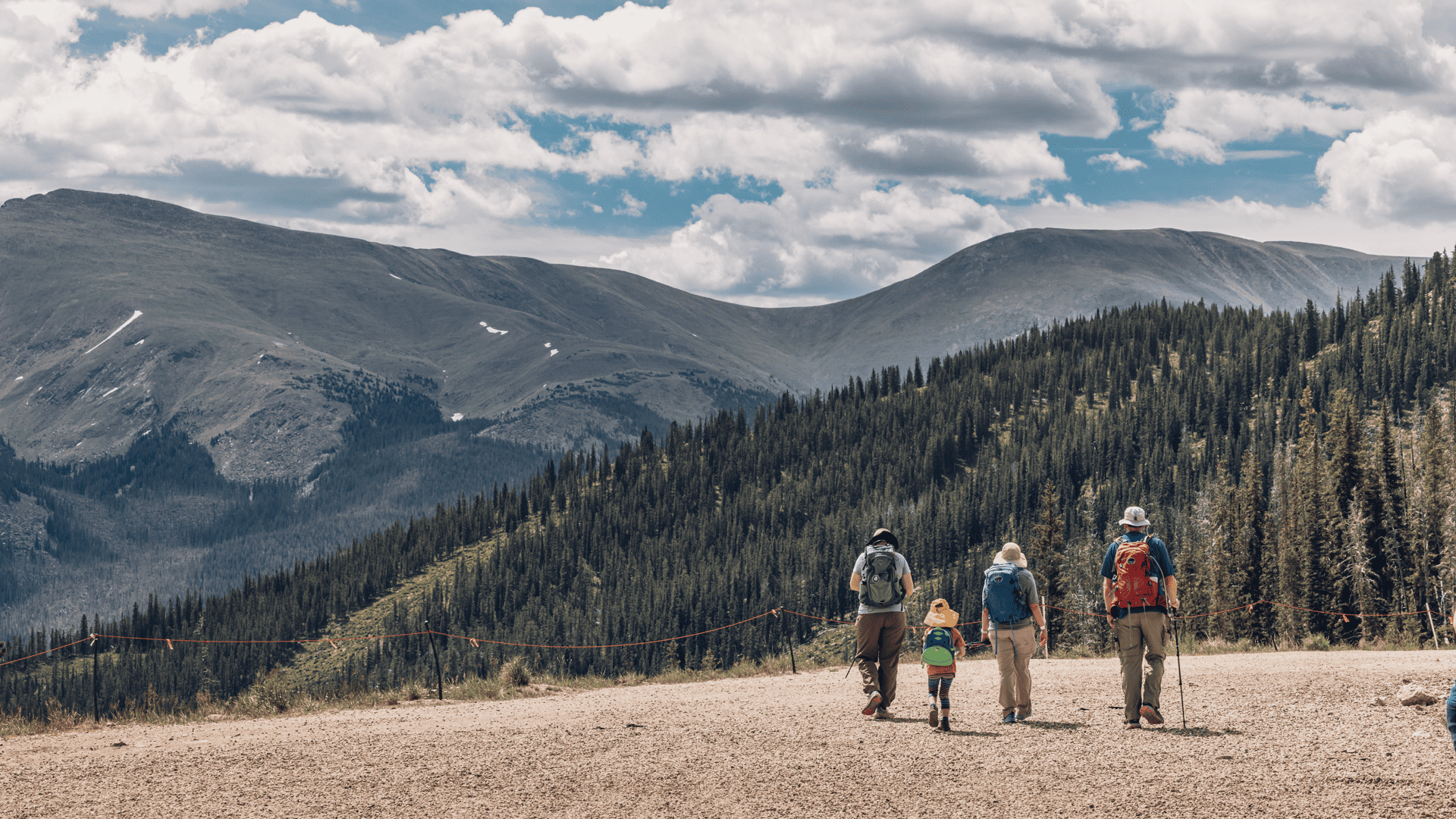 A group of people walking on a dirt road in Winter Park near the Continental Divide.