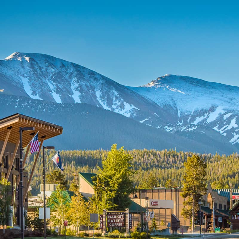 A town with snowy mountains in the background.