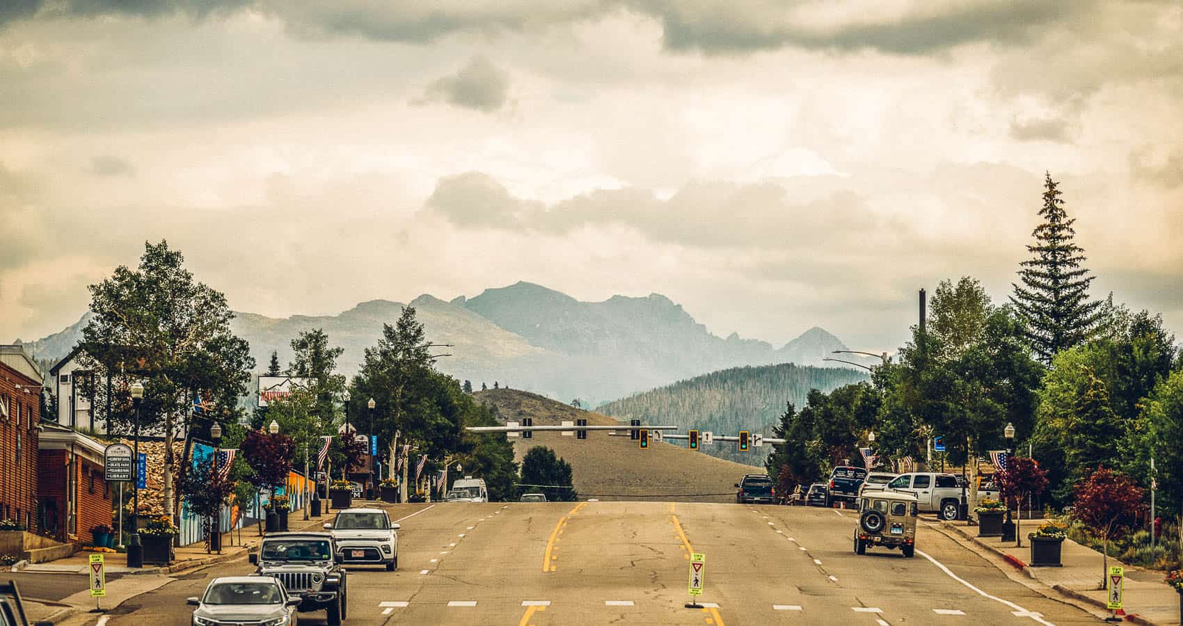 A Grand County, Colorado street in a town with mountains in the background.