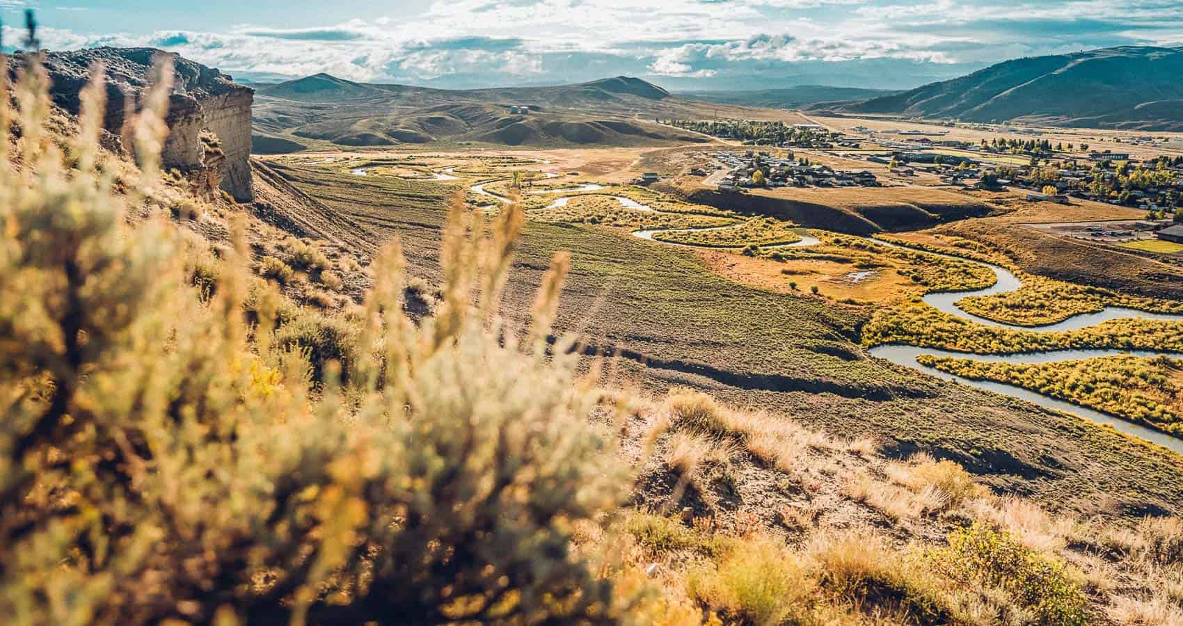 A view of a valley with a river running through it.