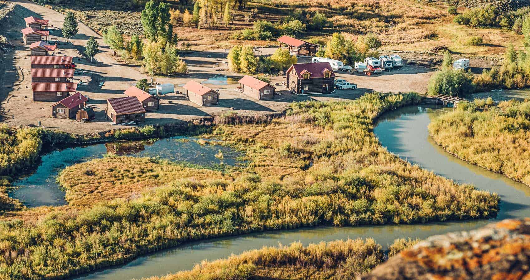 An aerial view of a village near a river.