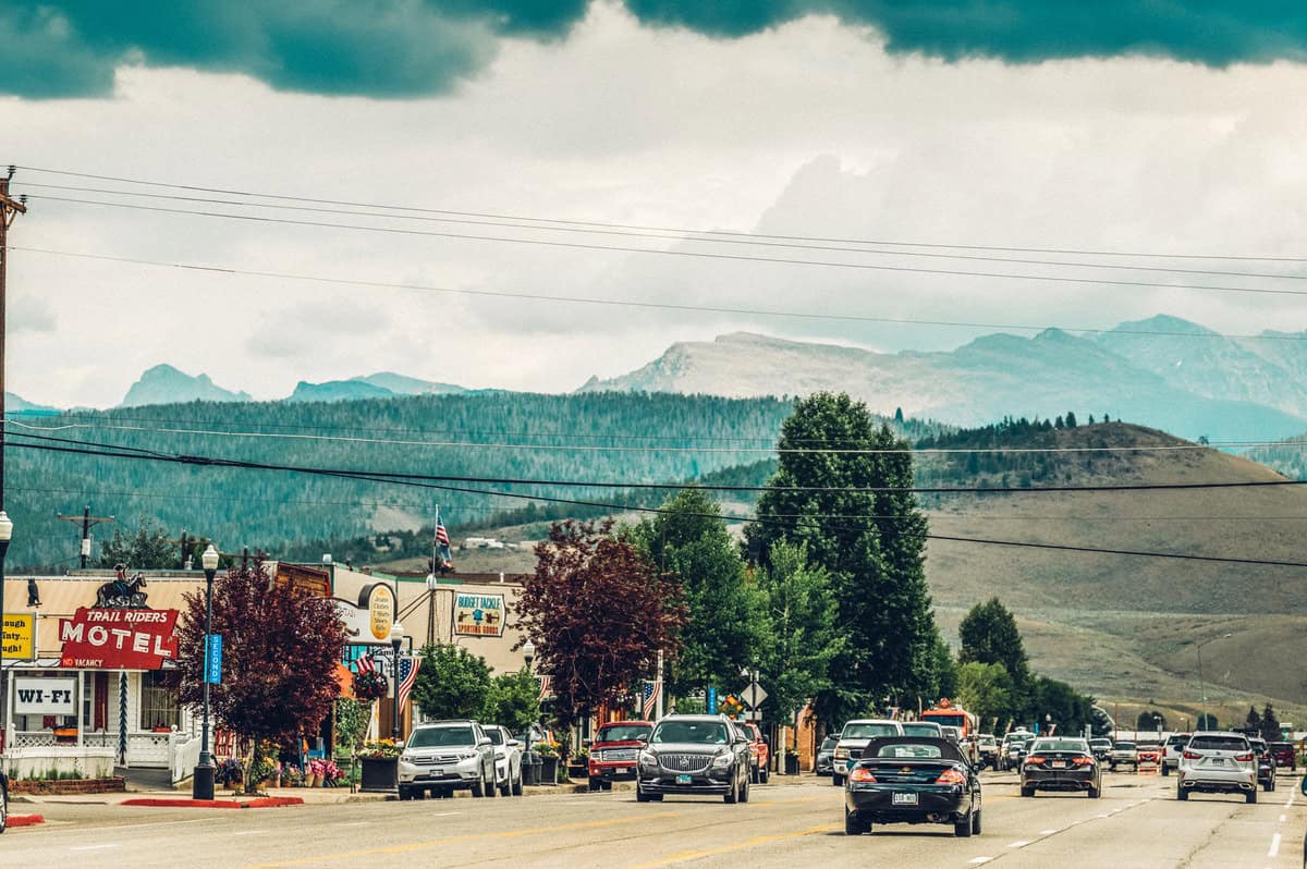 Cars driving in front of businesses in the downtown of Granby, Colorado