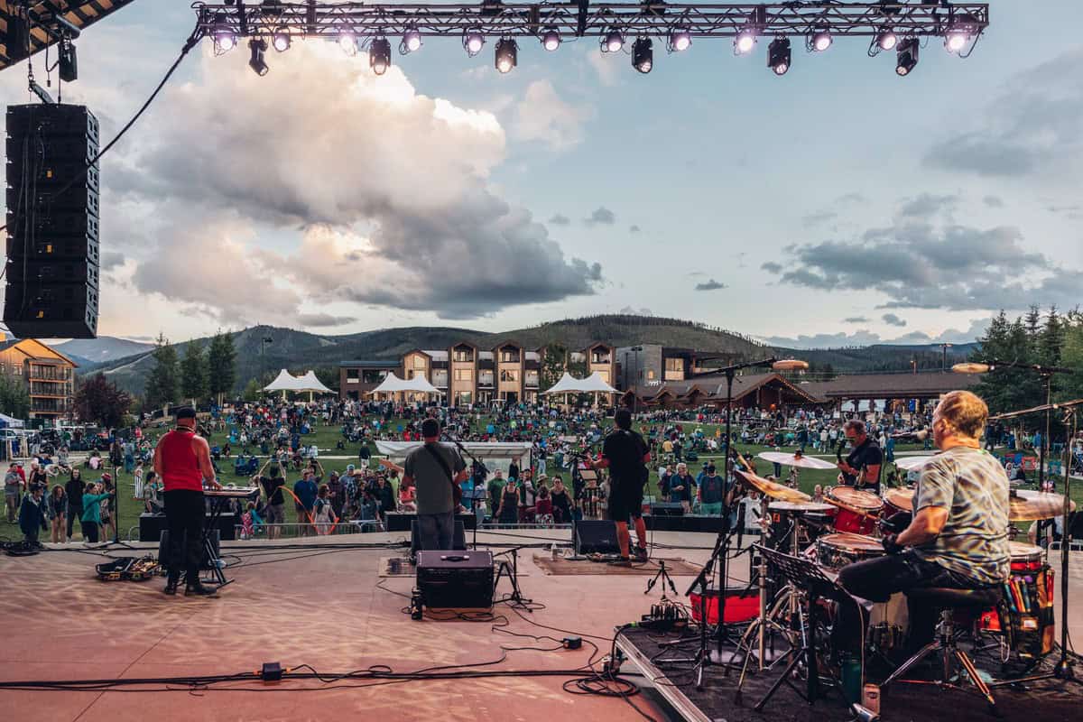 A band plays on the stage in Hideaway Park in at a Winter Park event